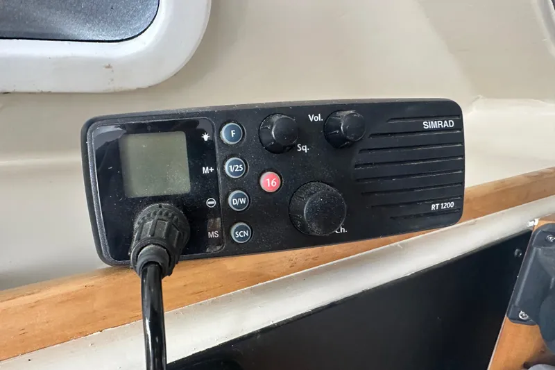 Slide: The Image of Simrad RT1200 radio on 1999 Baltec Engineering Visiona Catamaran dashboard. - 60