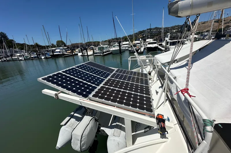 Slide: The Image of 1999 Baltec Engineering Visiona Catamaran with solar panels docked at a marina. - 16
