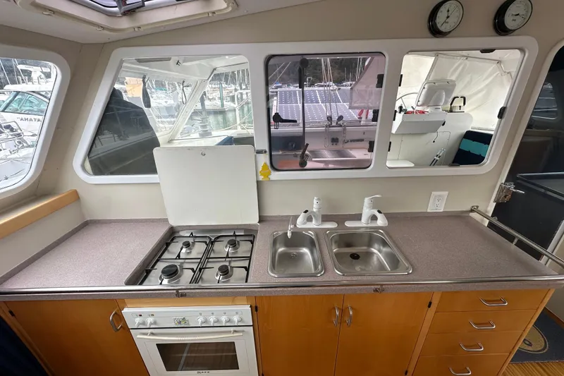 Slide: The Image of Interior view of a 1999 Baltec Engineering Visiona Catamaran kitchen with stove and dual sinks. - 23