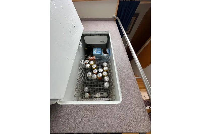 Slide: The Image of Open fridge on 1999 Baltec Engineering Visiona Catamaran, stocked with canned beverages. - 25