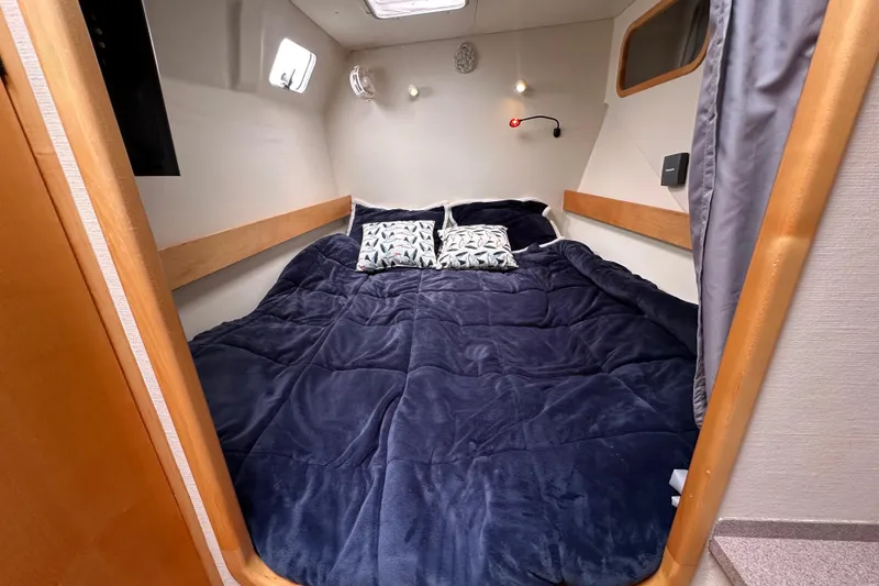Slide: The Image of Cozy cabin interior of 1999 Baltec Engineering Visiona Catamaran with plush bedding and pillows. - 29