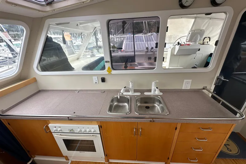 Slide: The Image of Interior of 1999 Baltec Engineering Visiona Catamaran kitchen with sink and stove. - 24
