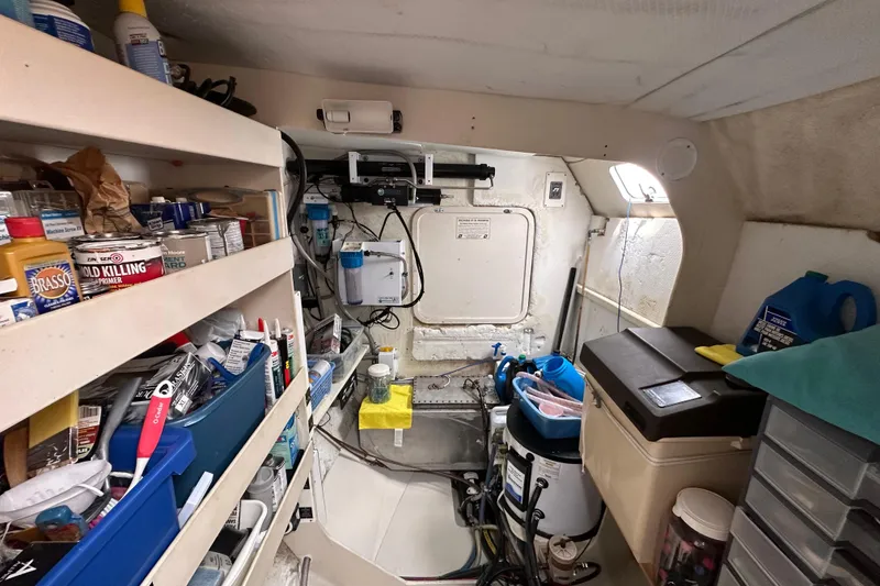 Slide: The Image of Interior of a 1999 Baltec Engineering Visiona Catamaran, featuring storage shelves and maintenance equipment. - 59