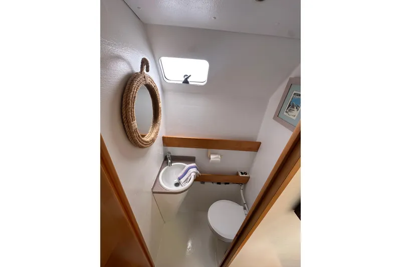 Slide: The Image of Bathroom interior of 1999 Baltec Engineering Visiona Catamaran with sink, toilet, and nautical decor. - 31