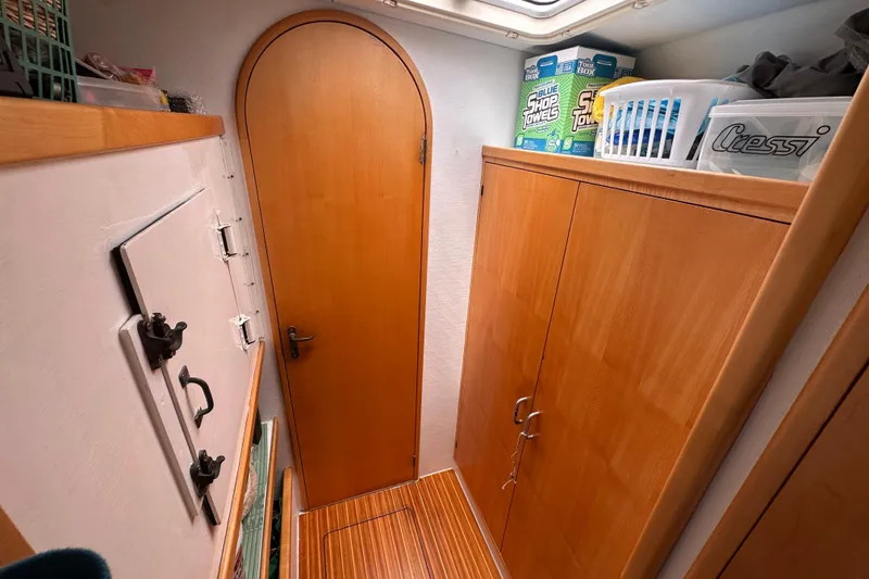 Slide: The Image of Interior of 1999 Baltec Engineering Visiona Catamaran with wooden cabinets and storage space. - 52