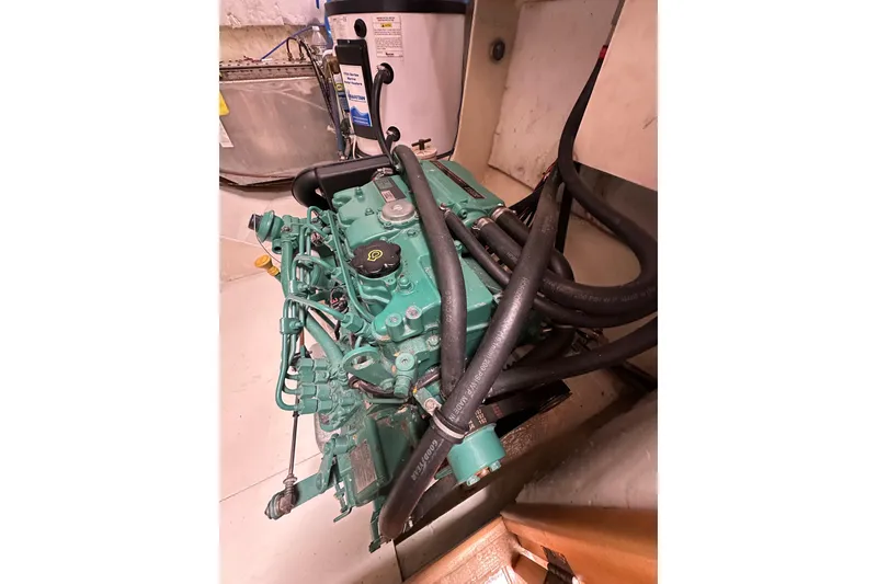 Slide: The Image of Engine room of a 1999 Baltec Engineering Visiona Catamaran, featuring complex machinery and hoses. - 54