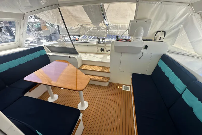 Slide: The Image of Interior of 1999 Baltec Engineering Visiona Catamaran with seating and wooden table. - 20