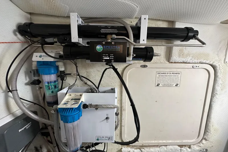 Slide: The Image of Water filtration system inside 1999 Baltec Engineering Visiona Catamaran, featuring Spectra Watermakers equipment. - 57