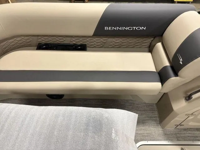 Slide: The Image of The interior of a Bennington boat with beige and gray upholstery and quilted design. - 11