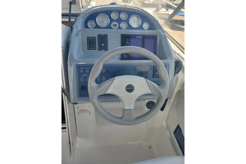 Slide: The Image of Steering console of a 2004 Bayliner 285 boat with gauges and controls. - 15