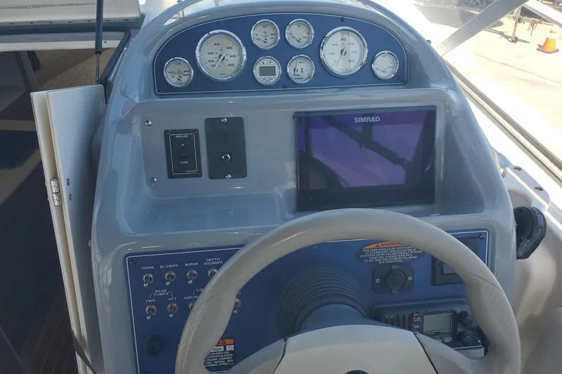 Slide: The Image of Control panel of a 2004 Bayliner 285 boat with gauges and Simrad display. - 14