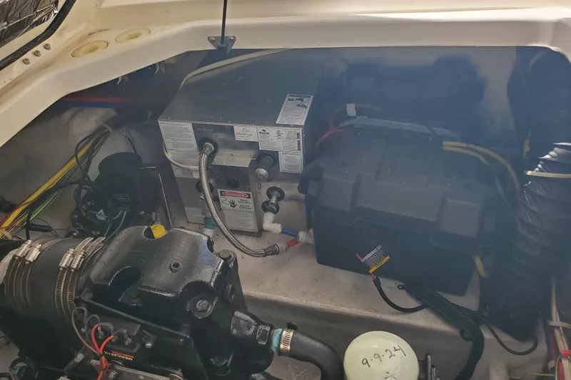 Slide: The Image of Engine compartment of a 2004 Bayliner 285 boat, showcasing mechanical components and wiring. - 28