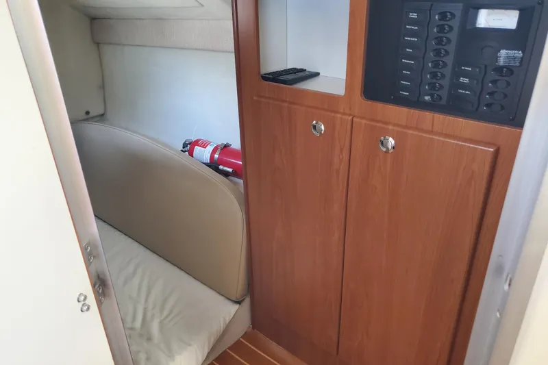 Slide: The Image of Interior of 2004 Bayliner 285 boat with wood cabinetry and fire extinguisher. - 10