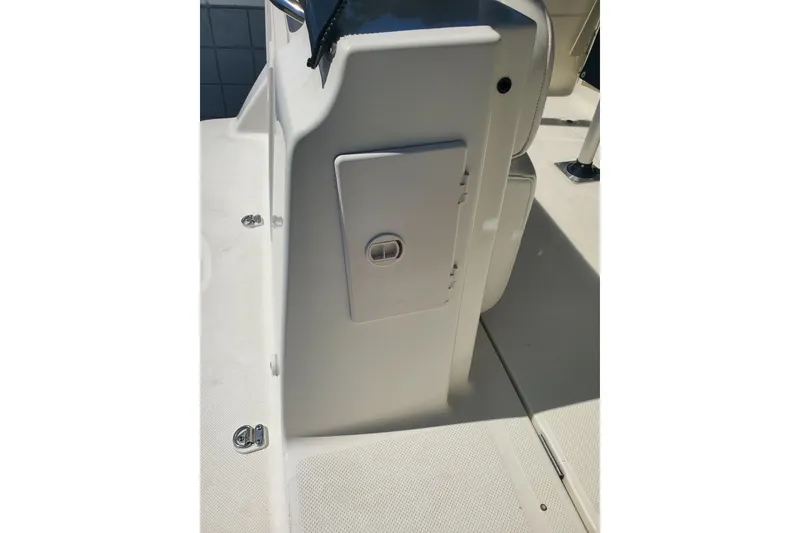 Slide: The Image of 2004 Bayliner 285 boat interior detail, featuring a storage compartment and seating area. - 26