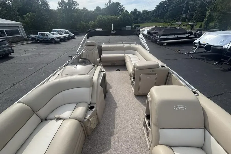 Slide: The Image of 2011 Harris Royal Heritage 260 I/O boat with beige seating, parked in a lot. - 26