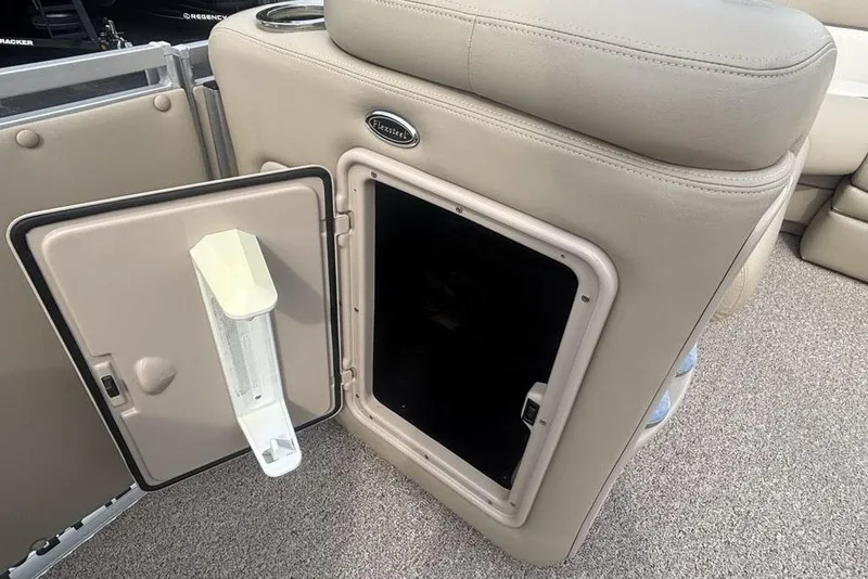 Slide: The Image of Open storage compartment on 2011 Harris Royal Heritage 260 I/O boat with beige upholstery. - 23