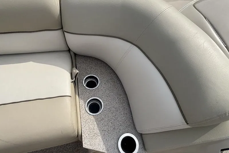 Slide: The Image of 2011 Harris Royal Heritage 260 I/O boat interior with beige seating and built-in cup holders. - 15