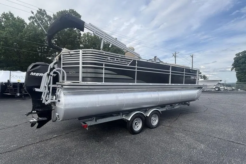 Slide: The Image of 2011 Harris Royal Heritage 260 I/O pontoon boat on trailer, parked outdoors. - 3