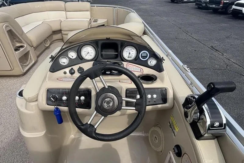 Slide: The Image of 2011 Harris Royal Heritage 260 I/O boat dashboard with steering wheel and controls. - 28