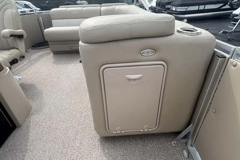 Slide: The Image of 2011 Harris Royal Heritage 260 I/O boat interior with beige seating and storage compartment. - 22