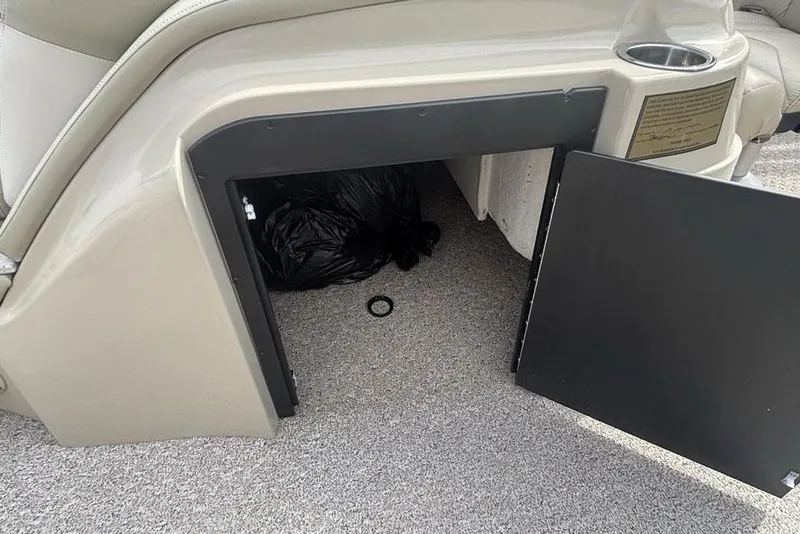 Slide: The Image of Open storage compartment on 2011 Harris Royal Heritage 260 I/O boat, revealing interior space. - 24