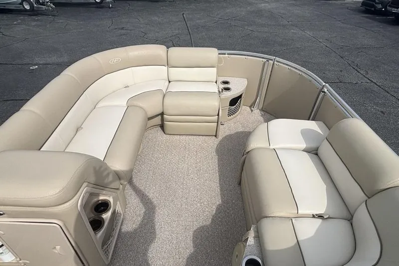 Slide: The Image of Luxurious seating on a 2011 Harris Royal Heritage 260 I/O boat, featuring beige upholstery. - 4