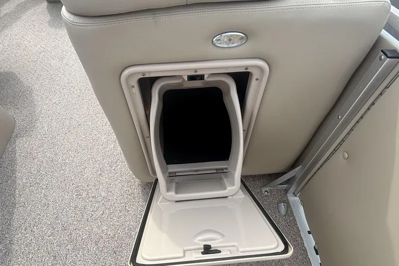 Slide: The Image of Open storage compartment on a 2011 Harris Royal Heritage 260 I/O boat. - 19