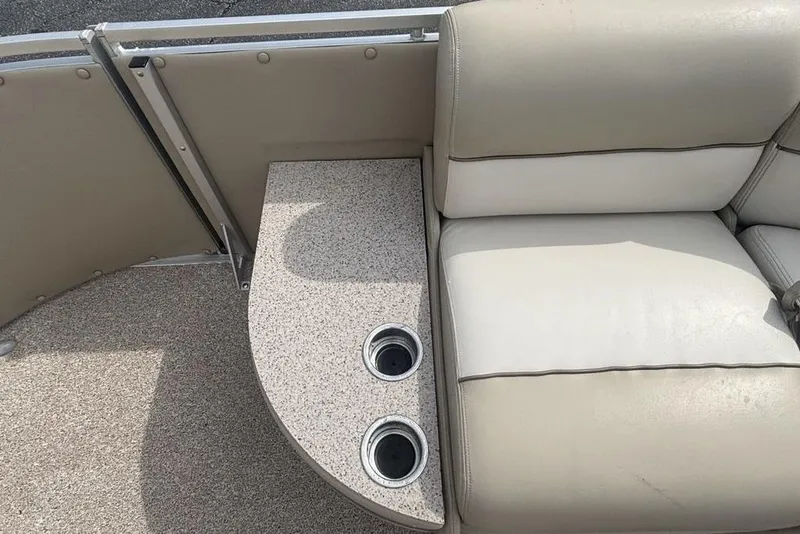 Slide: The Image of Interior of 2011 Harris Royal Heritage 260 I/O boat with beige seating and cup holders. - 13