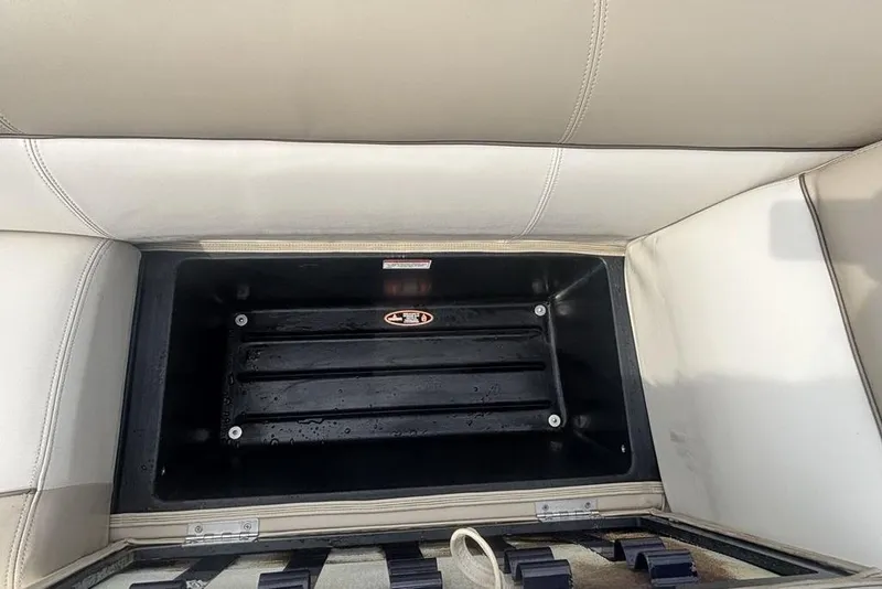 Slide: The Image of Open storage compartment in 2011 Harris Royal Heritage 260 I/O boat with beige seating. - 8