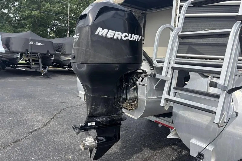 Slide: The Image of 2011 Harris Royal Heritage 260 I/O boat with Mercury outboard motor in a parking lot. - 29