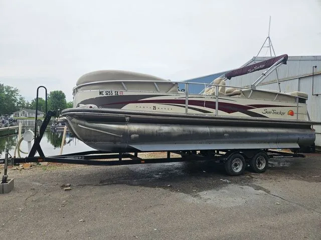 Slide: The Image of A 2008 Tracker Regency Party Barge pontoon boat on a trailer beside a calm harbor. - 19