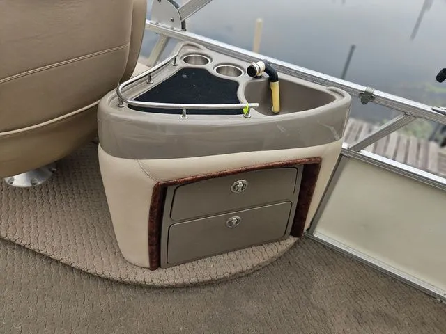 Slide: The Image of A sleek console with cup holders and storage on a 2008 Tracker Regency Party Barge. - 22