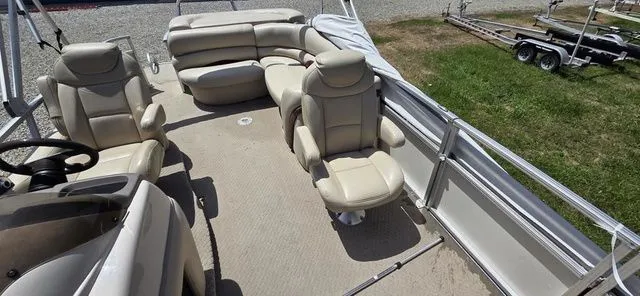 Slide: The Image of The image shows the deck of a 2008 Tracker Regency Party Barge with beige seating. - 8