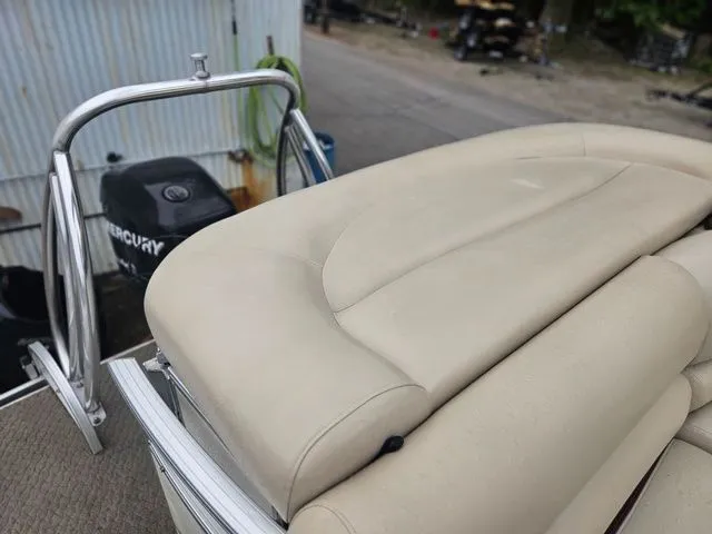 Slide: The Image of A 2008 Tracker Regency Party Barge with beige upholstery and a Mercury outboard motor. - 26