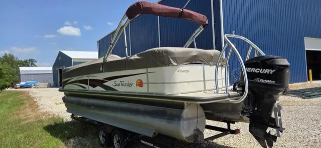 Slide: The Image of A 2008 Tracker Regency Party Barge pontoon boat on a trailer in front of a blue building. - 4