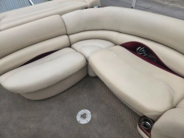Slide: The Image of Beige upholstered seating area on a boat with cup holders and carpeted floor. - 21