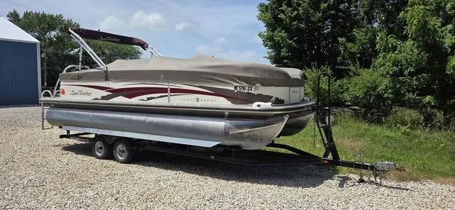 Slide: The Image of A 2008 Tracker Regency Party Barge pontoon boat on a trailer, covered and ready for transport. - 12