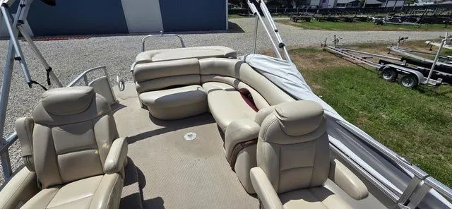 Slide: The Image of A 2008 Tracker Regency Party Barge with beige leather seating and an open deck layout. - 6