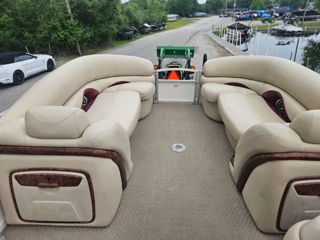 Slide: The Image of The image shows the interior of a 2008 Tracker Regency Party Barge with beige seating. - 25