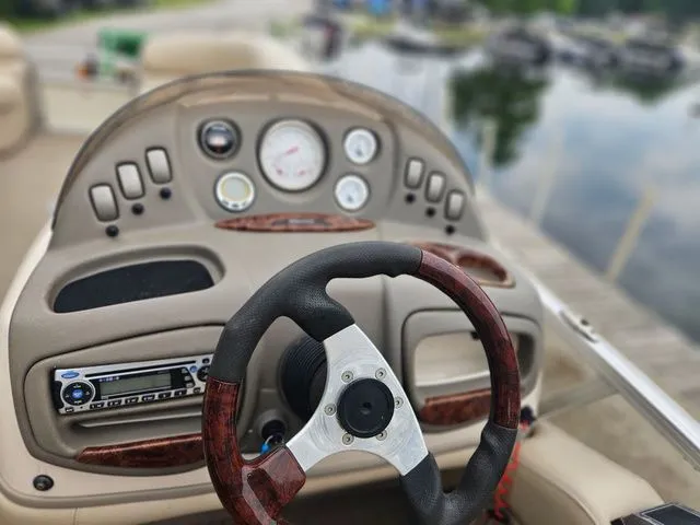 Slide: The Image of The image shows the helm of a 2008 Tracker Regency Party Barge with a stylish steering wheel. - 3