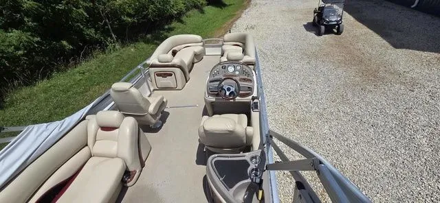 Slide: The Image of A 2008 Tracker Regency Party Barge with beige seating and a central helm station. - 11