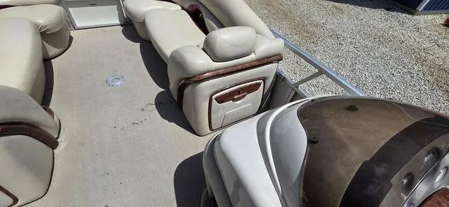 Slide: The Image of The image shows the interior of a 2008 Tracker Regency Party Barge with beige seating. - 15