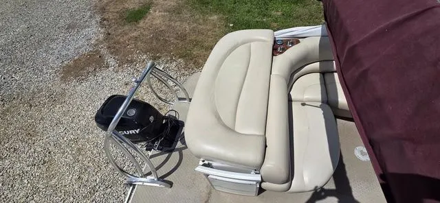 Slide: The Image of A 2008 Tracker Regency Party Barge with beige upholstered seating and a Mercury outboard motor. - 13