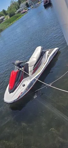Slide: The Image of A 2019 Yamaha WaveRunner EX floats on calm water, featuring a red and gray seat. - 8
