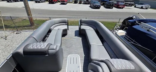 Slide: The Image of The image shows the interior of a 2020 Bennington 25 RXSBA with gray upholstered seating. - 2