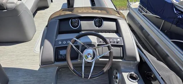 Slide: The Image of The image shows the helm of a 2020 Bennington 25 RXSBA with modern instruments. - 4