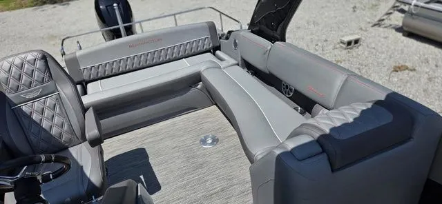 Slide: The Image of The image shows the gray upholstered seating area of a 2020 Bennington 25 RXSBA boat. - 6