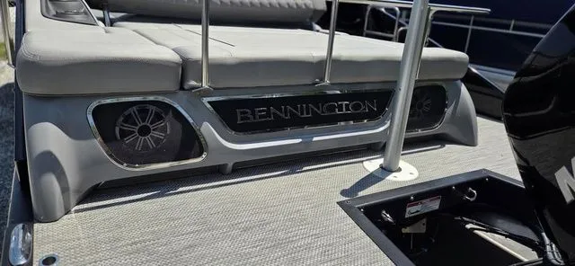 Slide: The Image of The image shows the rear of a 2020 Bennington 25 RXSBA with speakers and cushions. - 15