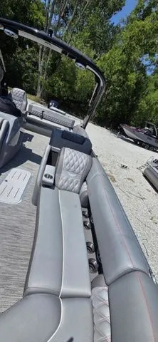 Slide: The Image of The image shows the interior of a Bennington 25 RXSBA boat with gray upholstery and an open deck. - 9