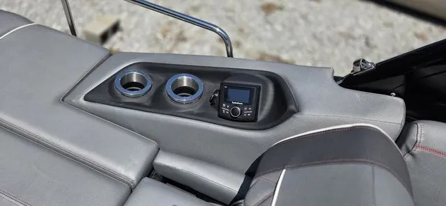 Slide: The Image of The gray boat seating features built-in cup holders and a control panel. - 20